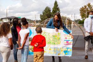 Brenda Mallory – Chairwoman of the White House's Council on Environmental Quality (dark blue puffy Patagonia jacket, blue/red scarf) engaged children at Jennie Reed Elementary in Tacoma, WA in design workshops.