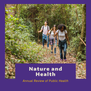 Three young adults hiking in a forest