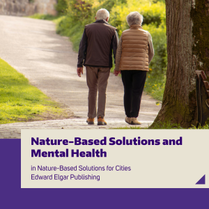 Two older adults walking in a tree-filled park