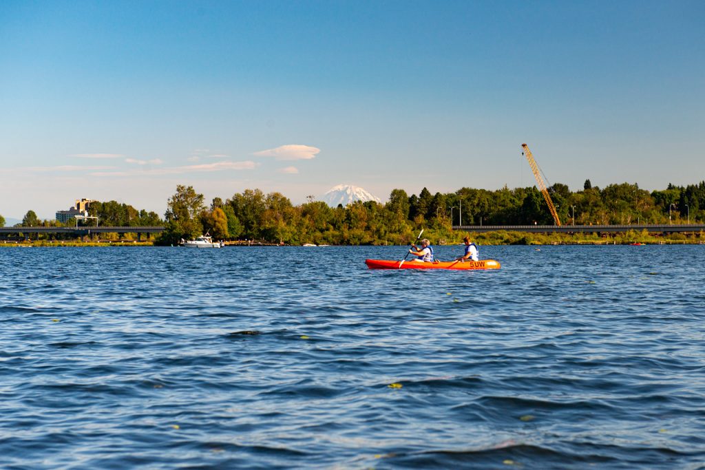 Two people kayaking on Lake Washington with Mount Rainier/Mount Tahoma in the background