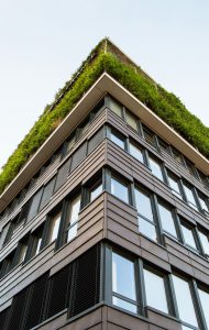 A high rise building with a green/planted roof