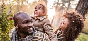 Two parents outdoors with their child