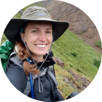 A photo of Allie hiking and wearing a wide-brimmed hat