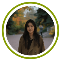 Yuxuan stands in front of trees with fall colors