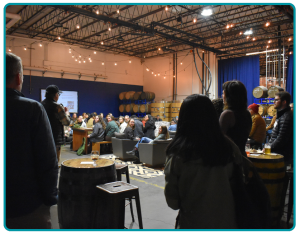 A group of 70 people listening to speakers at the October 2025 Community Dinner