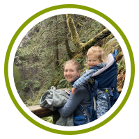 Sarah is on a hike and carries her child on her back