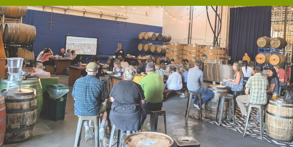 A group of people listening to a speaker at a previous Nature and Health Community Dinner