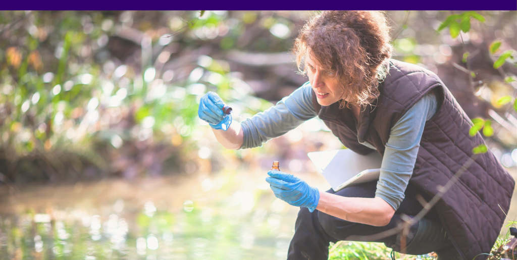 A scientist takes water samples from a river