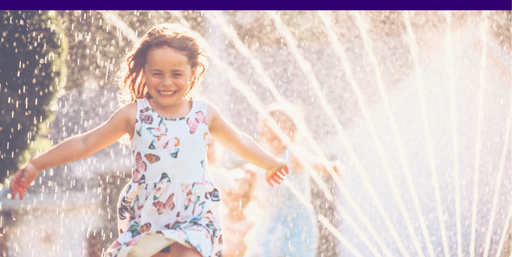 Children play in a sprinkler