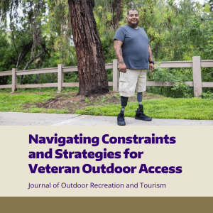 A veteran with two prosthetic legs walks in a park